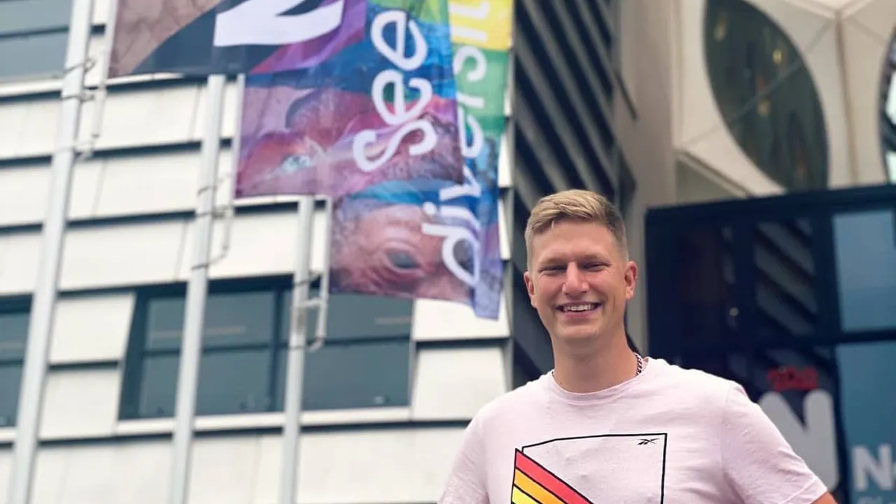 Werner de Gier and pride rainbow flags in front of Naturalis